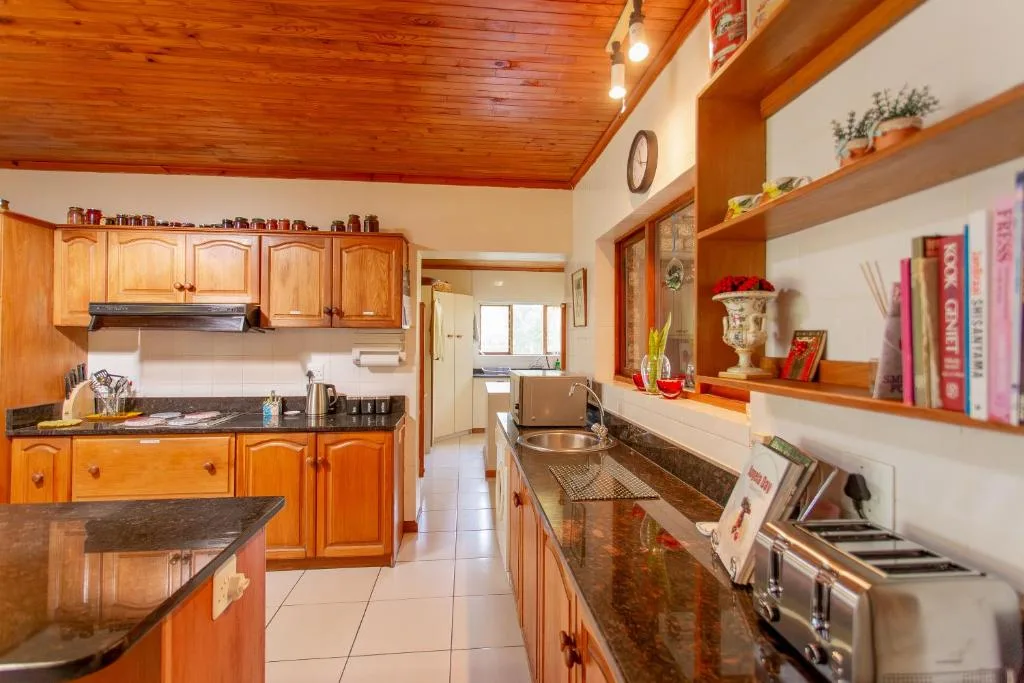 Spacious kitchen with wooden cabinetry, dark countertops, and stainless steel appliances