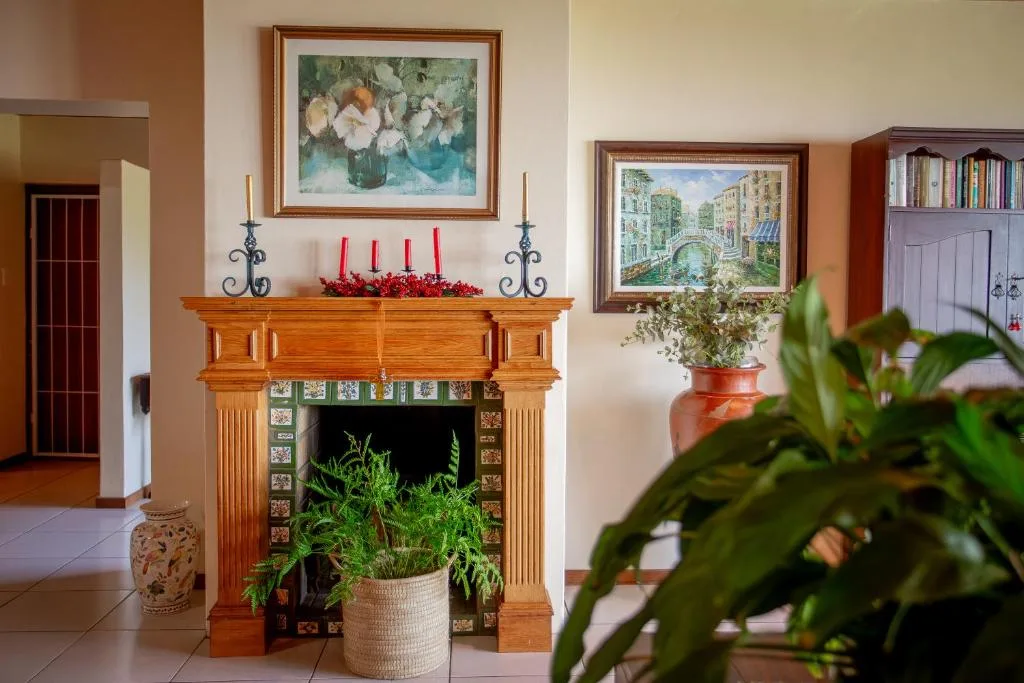 Elegant lounge with wooden fireplace, mantelpiece decor, and framed artwork