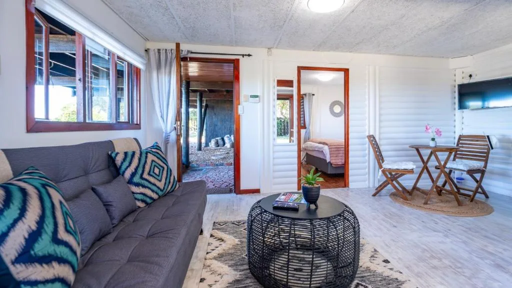 Modern living room with grey sofa, woven coffee table, and wooden furniture