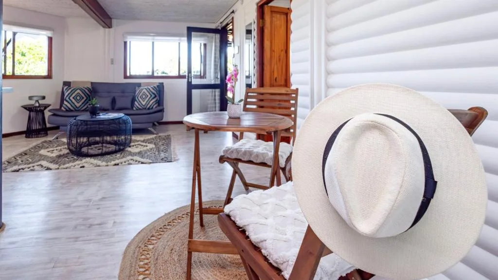 Spacious lounge with sofa, round coffee table, and coastal decor