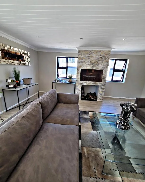 Modern lounge with gray sofa, fireplace, and stone accent wall