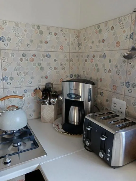 Kitchen counter with stove, coffee maker, and toaster appliances