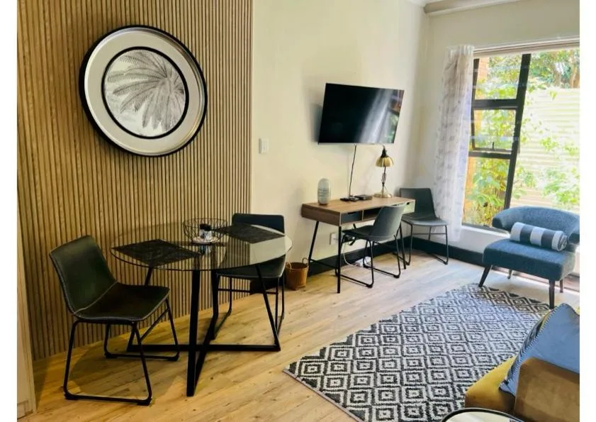 Modern lounge with TV, seating, and striped accent wall decoration