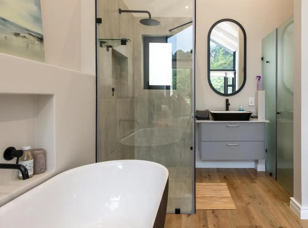 Modern bathroom with freestanding tub, walk-in shower, and vanity
