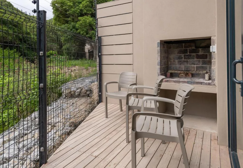 Outdoor deck with comfortable seating and integrated fireplace area