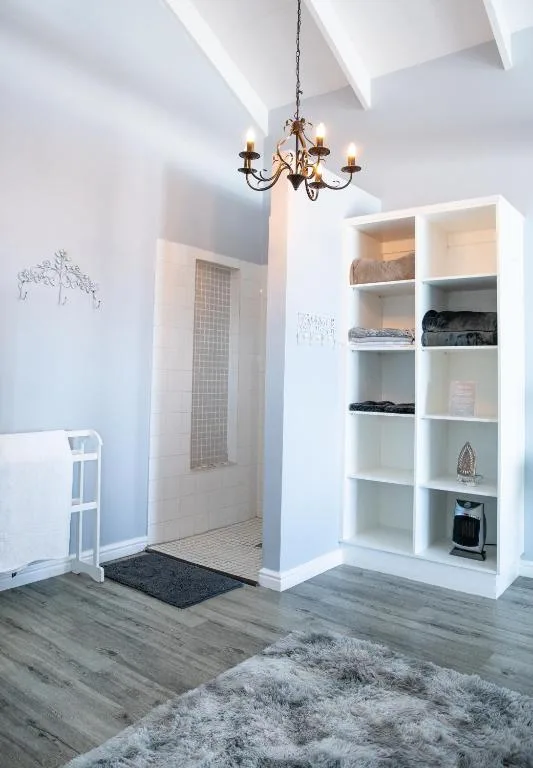 Modern white shelving unit with organized linens and home accessories