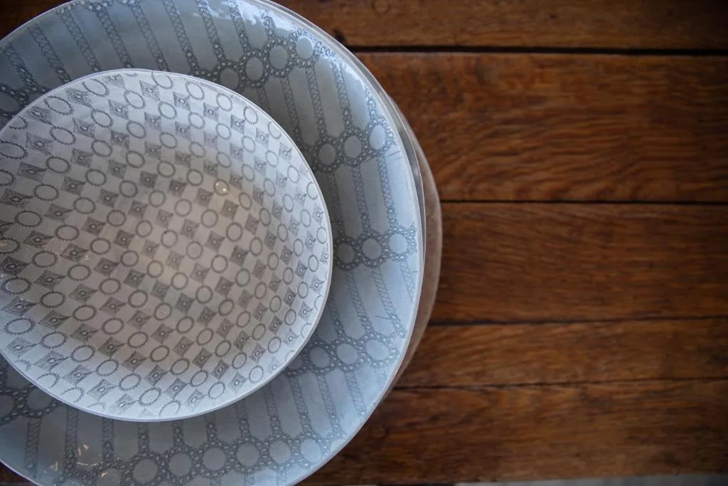 Stacked decorative bowls with geometric patterns on wooden flooring