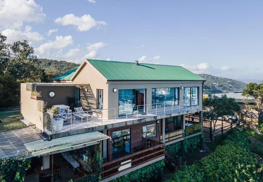 Modern self-catering home with green roof overlooking coastal landscape and gardens