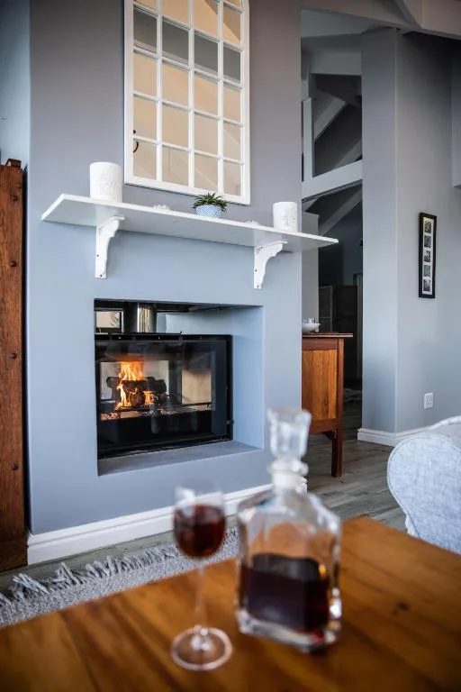 Modern lounge with fireplace, white shelf, and cozy seating area