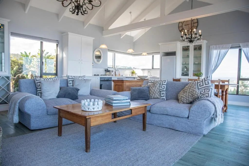 Open-plan lounge with blue upholstered seating and wooden coffee table