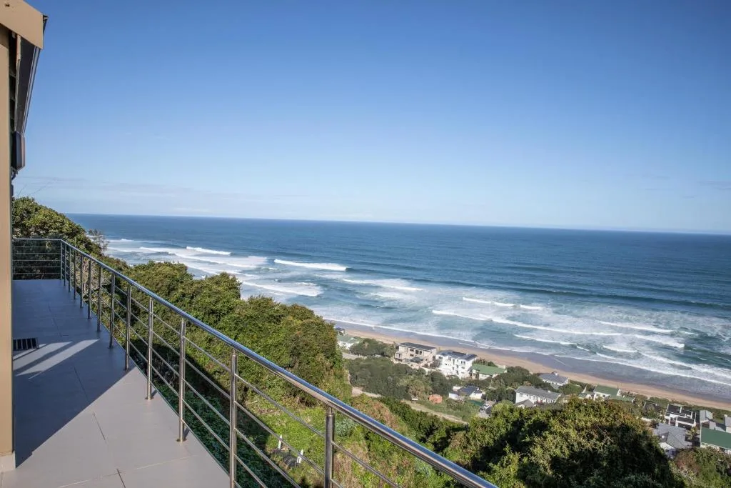 Expansive ocean vista with beach and waves from elevated deck