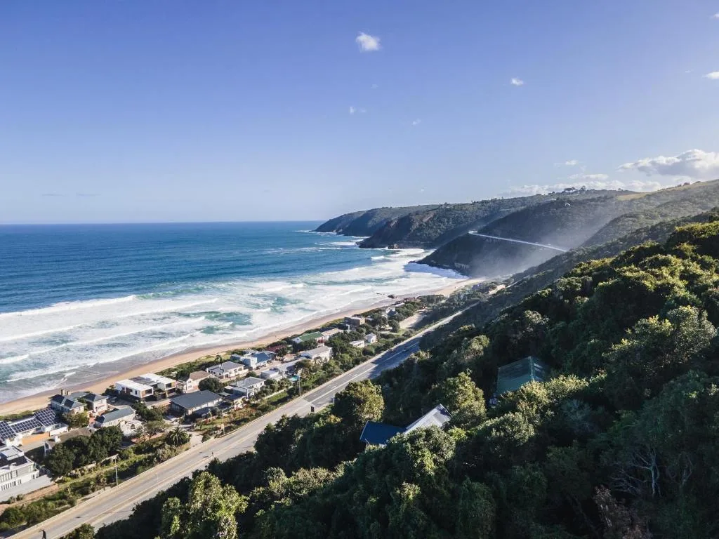 Panoramic coastal vista with beach, cliffs, and ocean from elevated vantage point