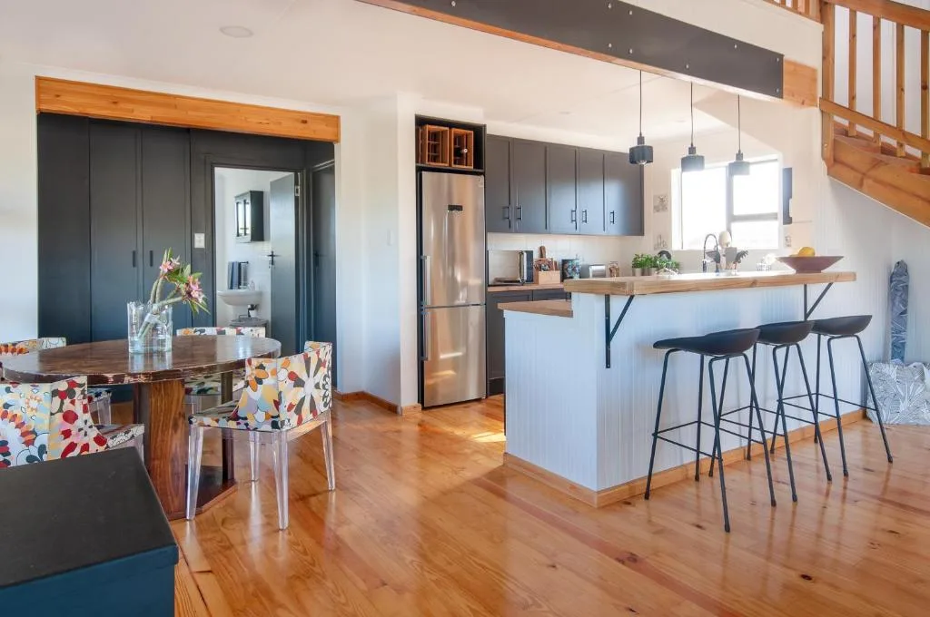 Modern kitchen with stainless steel appliances and wooden countertop bar seating