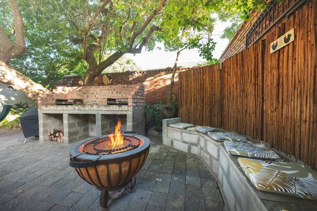 Outdoor entertaining area with fire pit and brick braai facility