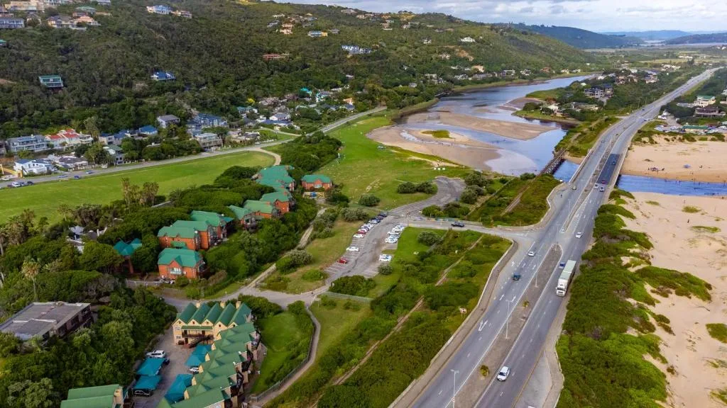 Aerial view of Wilderness lagoon, beach, and surrounding forested hills