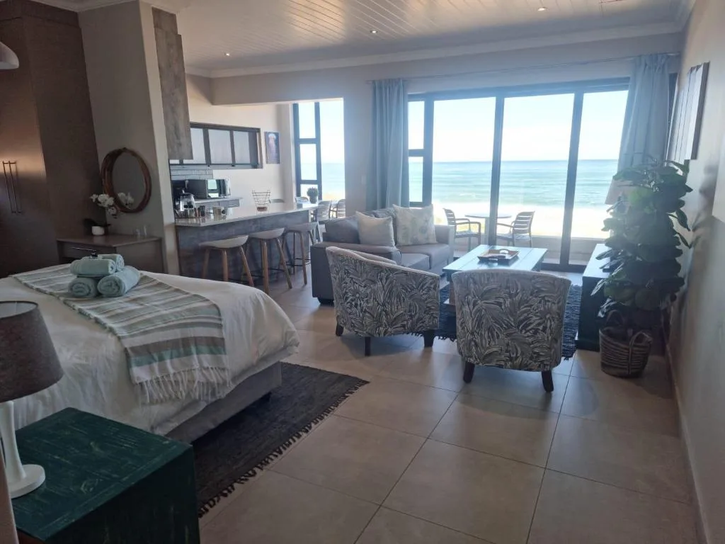 Spacious lounge with ocean view through large glass doors and windows