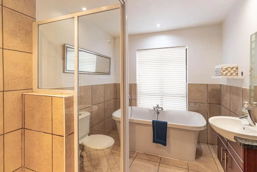 Modern bathroom with freestanding bath, walk-in shower, and double vanity