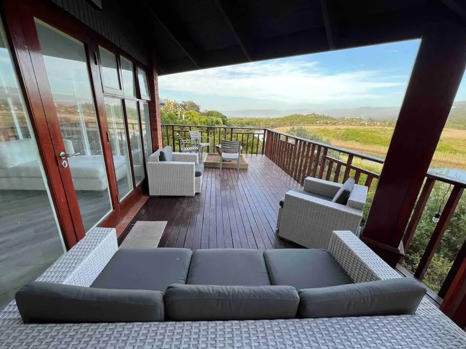 Spacious deck with outdoor seating overlooking lush valley landscape