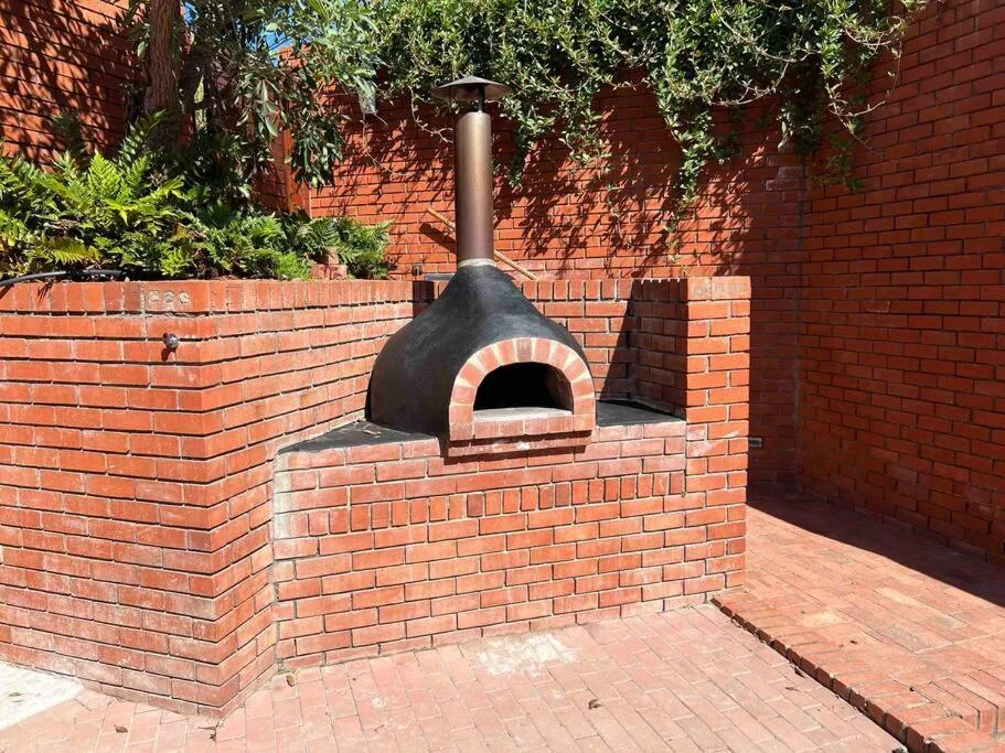 Brick braai area with traditional pizza oven on sheltered patio