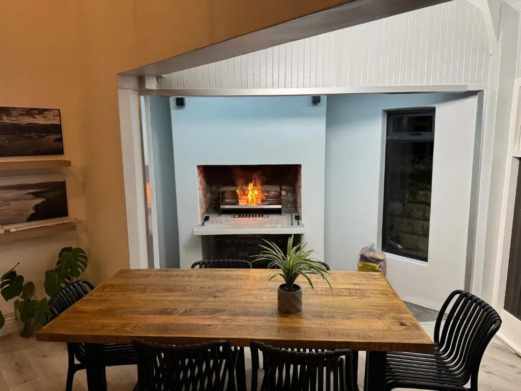 Dining table with fireplace and modern decor in background