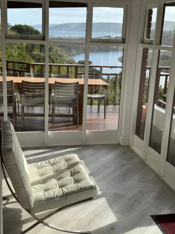Scenic coastal view of lagoon and cliffs from indoor deck access