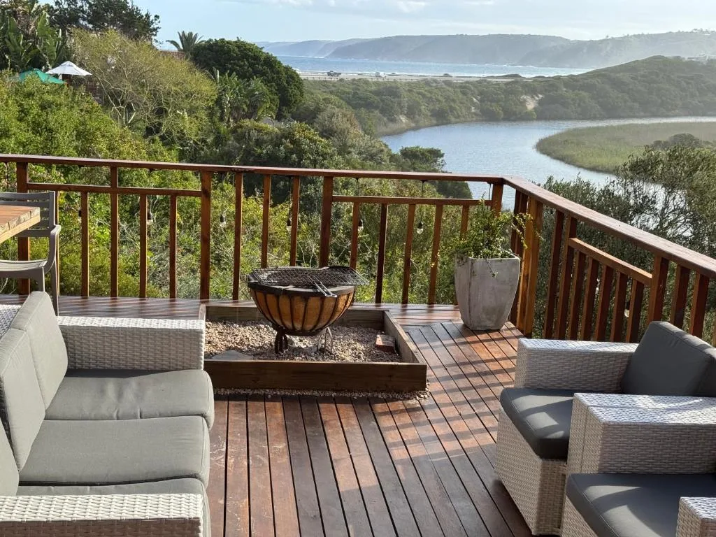 Lagoon and coastal mountains viewed from wooden deck with seating