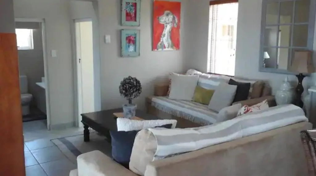Bright lounge with cream sofas, colorful wall art, and natural light