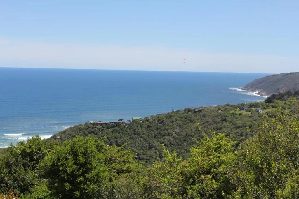 Sweeping coastal vista of Indian Ocean with forested cliffs and beach below